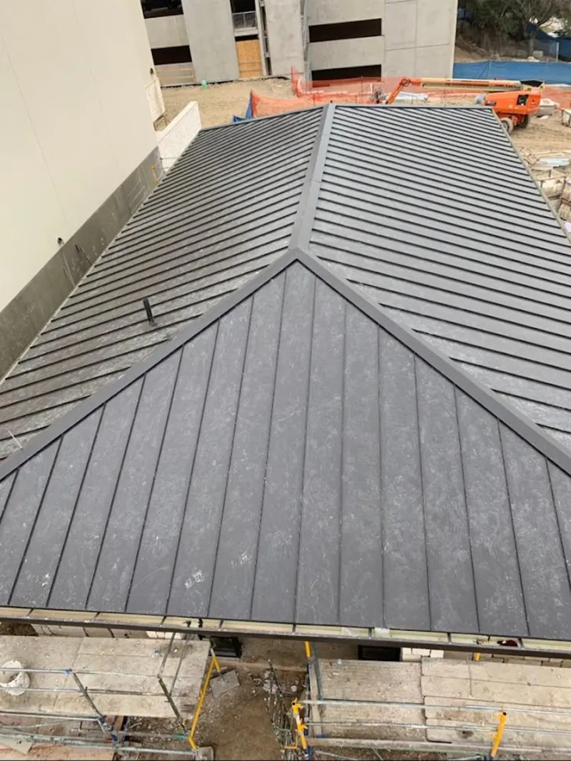Commercial metal roof construction with crane equipment in Warrensburg