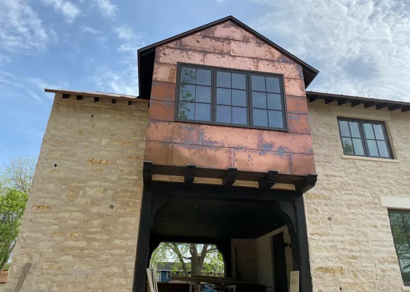 Copper metal panel facade on a stone building for Metal Roof Coating in Warrensburg